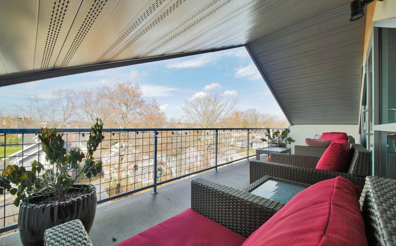 Upper-floor balcony detail with metal railing at 300 Hamilton mixed-use building