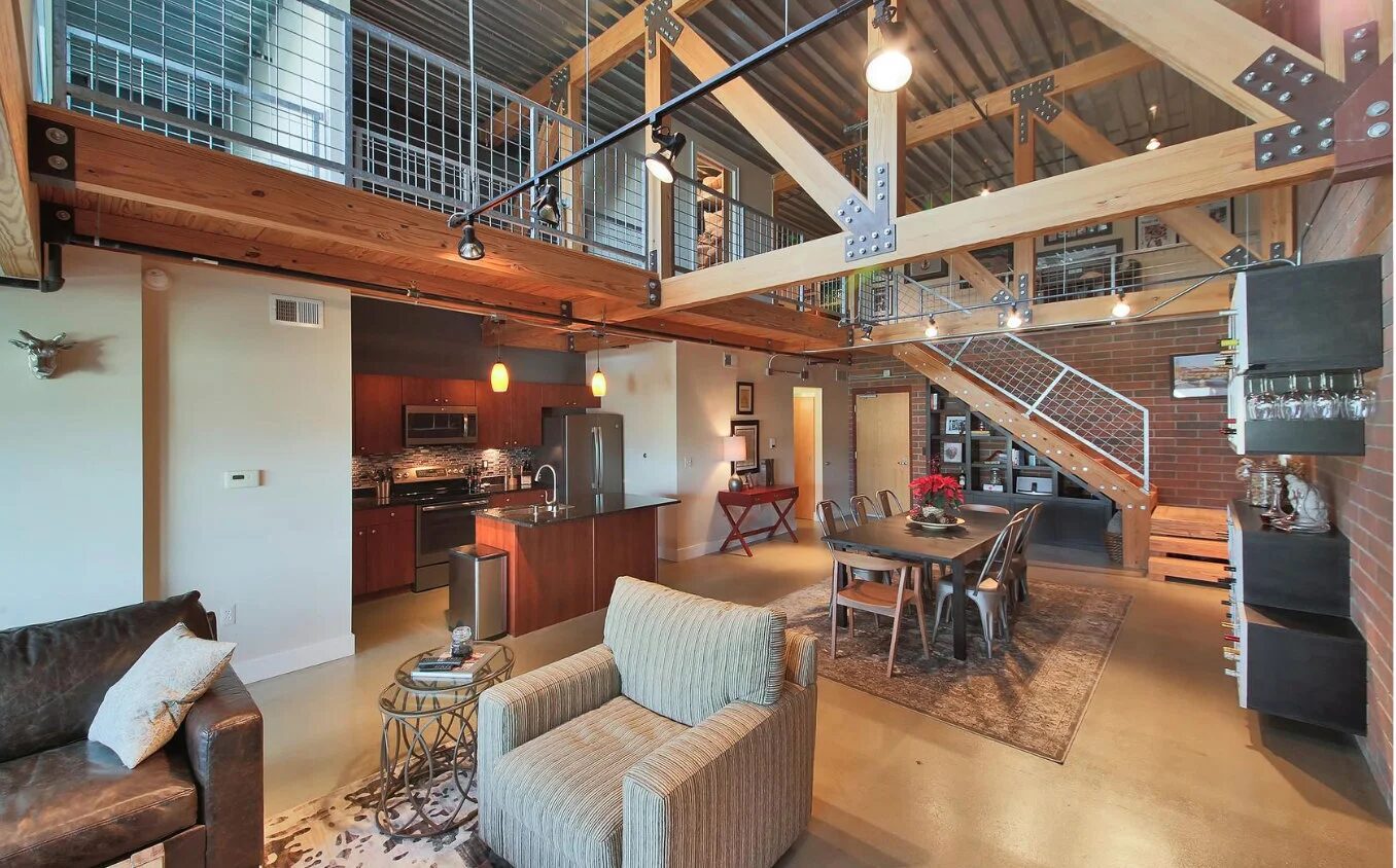 Kitchen area with blackened steel accents and warm wood cabinetry in Detroit loft