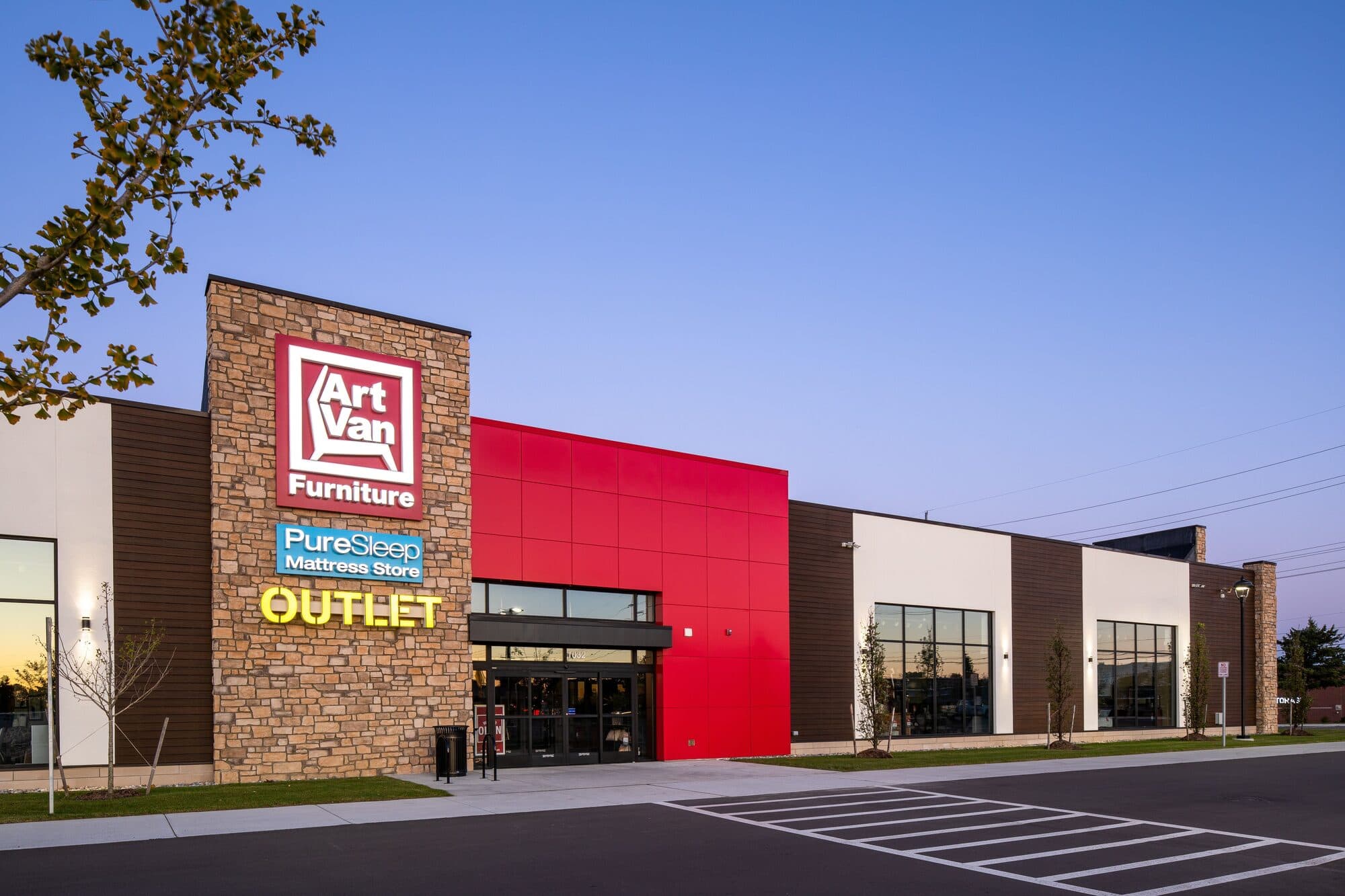Winchester Center commercial retail building at dusk in Rochester Hills Michigan with stone and glass facade